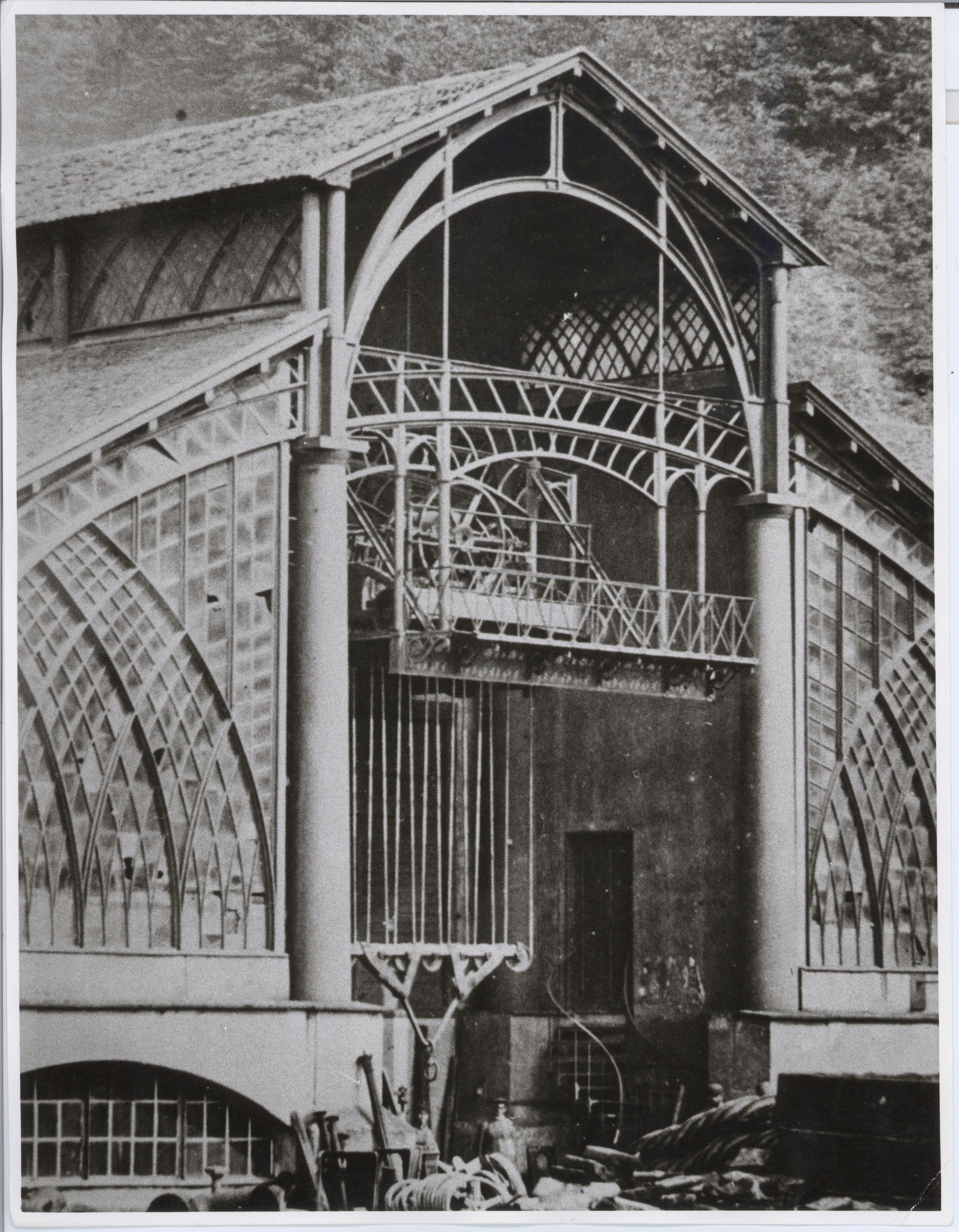 Part of the west façade with the crane runway, its hoist lowered; around 1869.