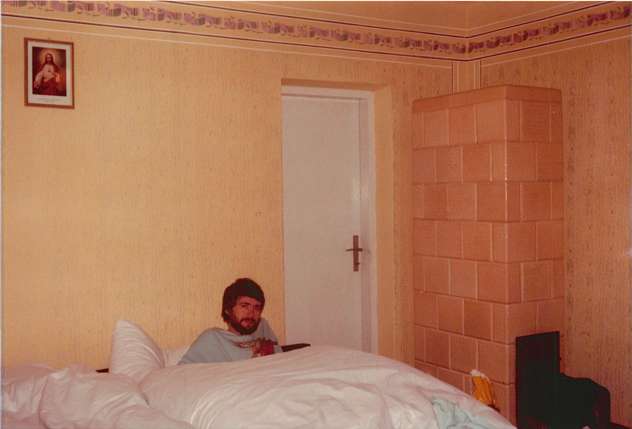 John in the big bed all four of us (Eleanor, Mayme, John & Lorraine) slept in at Genek & Jadwiga's home, with down covers