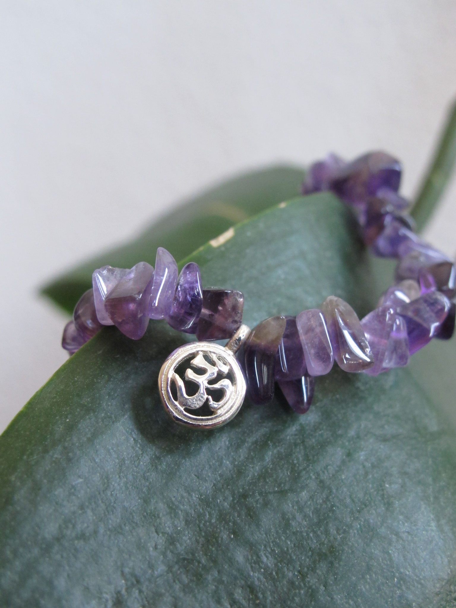 Chips of amethyst with a 925 Sterling silver "OM" charm (sold)