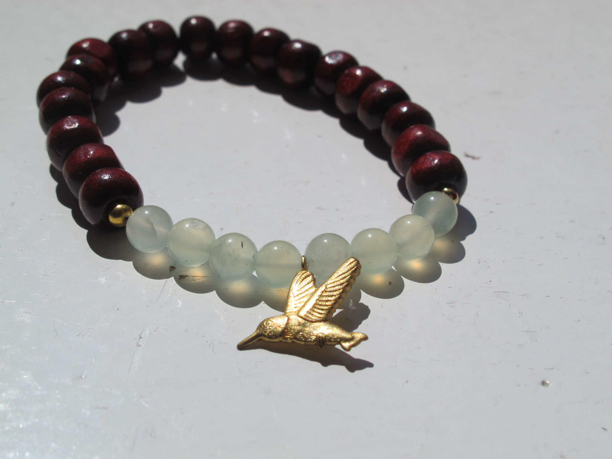 Serpentine with wood and a brass hummingbird charm