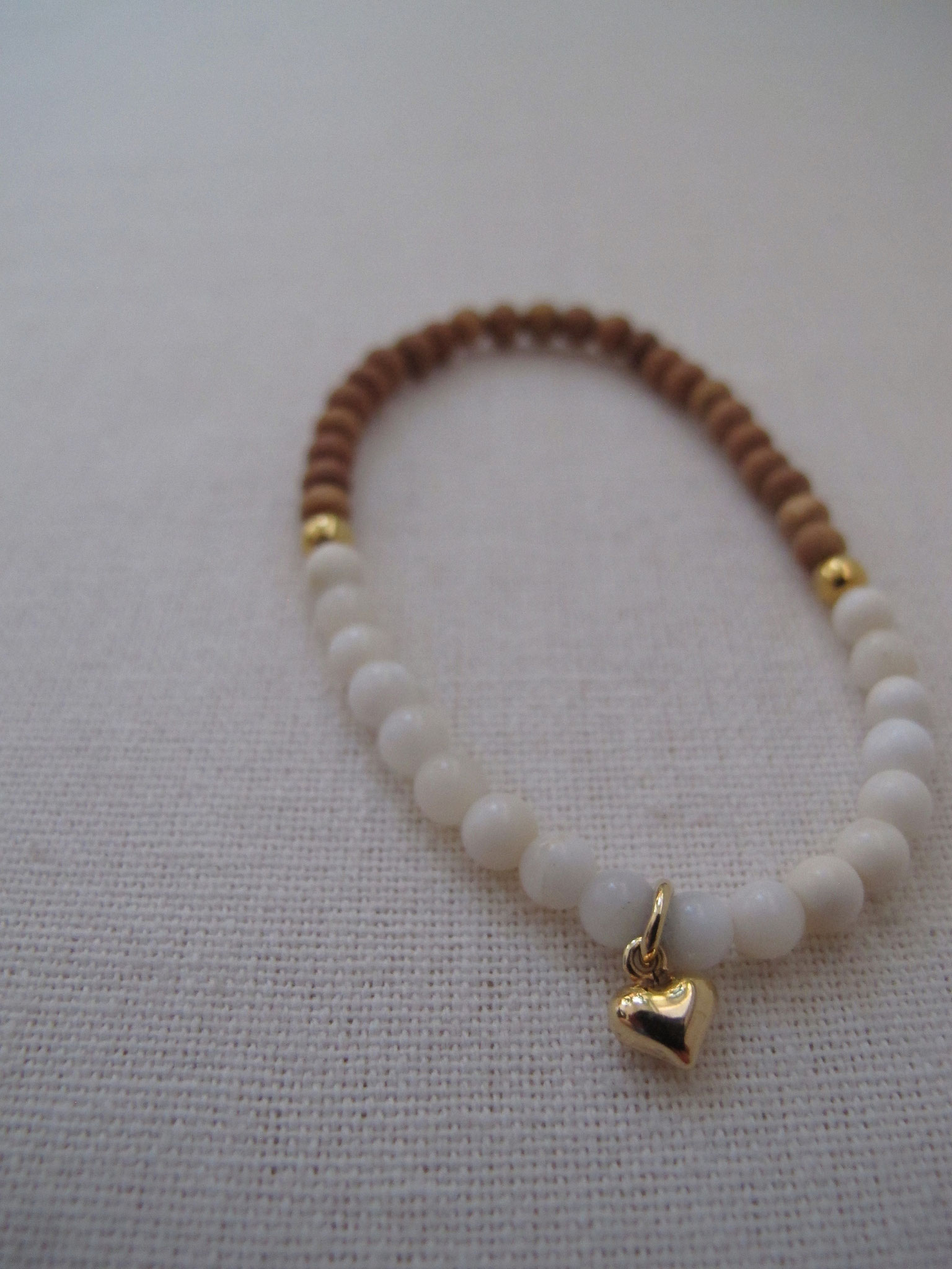 Gorgeous white opal in combination with sandal wood with gold-plated heart charm (sold)