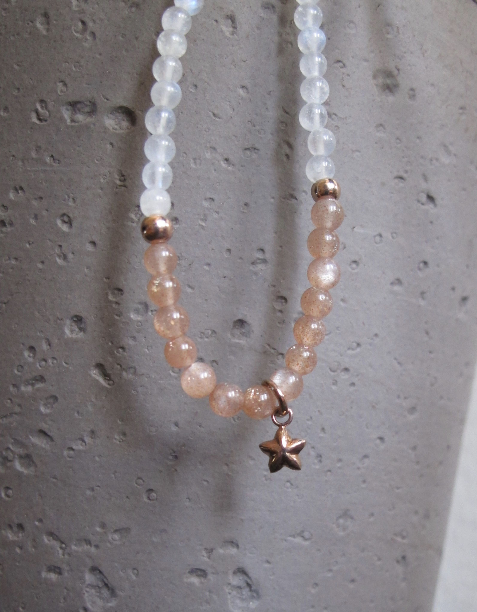 Rainbow coloured and rose coloured moonstone with a rose-gold-plated star charm