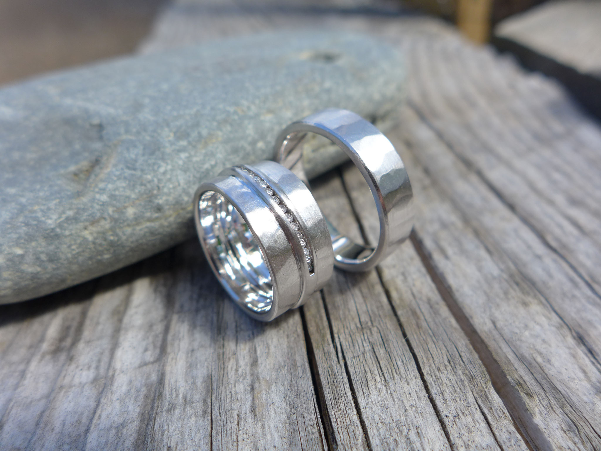 One of a kind: 14k palladium white gold. Her engagement ring is built in her wedding band, both rings have a hammered texture. Rhodium covered