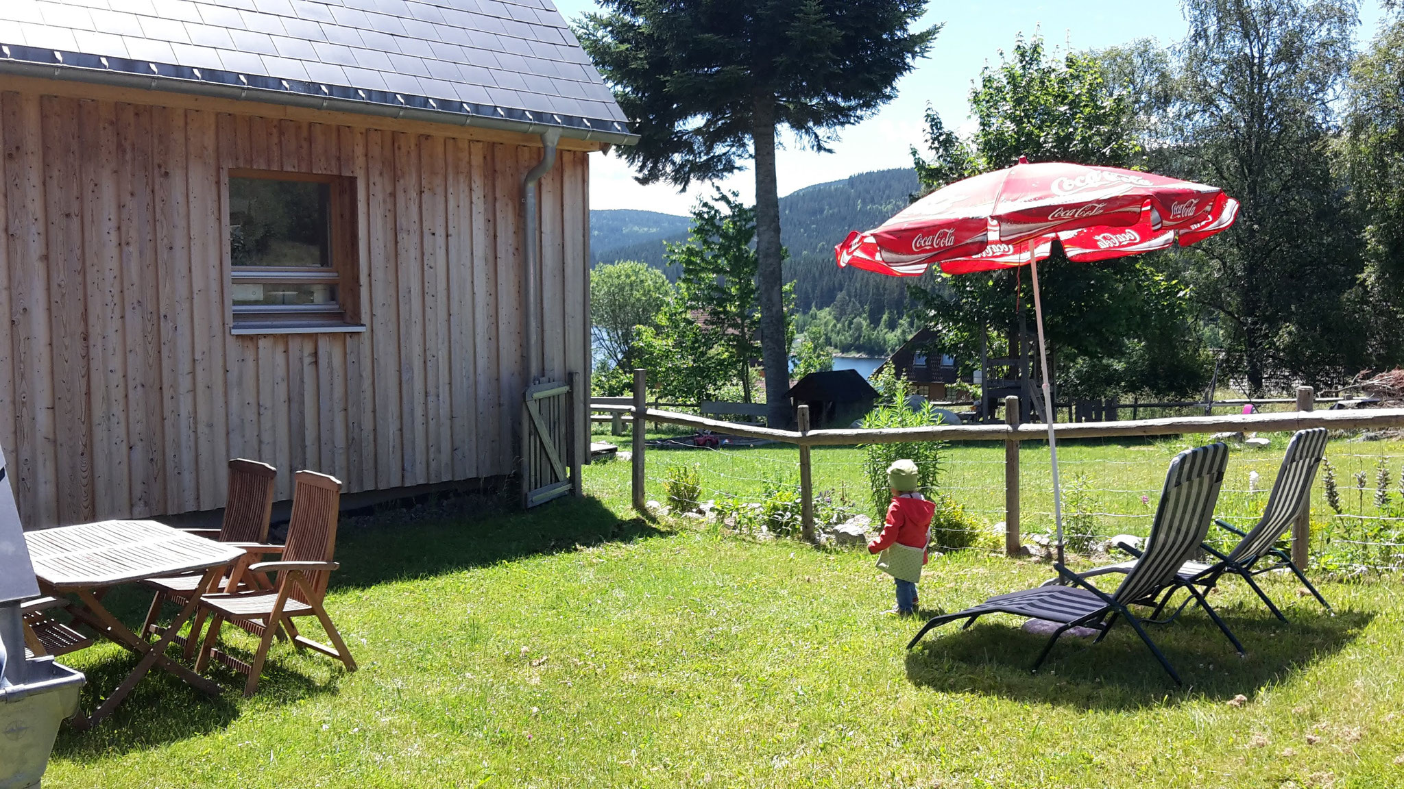 Im kleinen abgetrennten Gartenbereich finden Sie eine Sitzgelegenheit, Sonnenschirm sowie 2 Liegestühle
