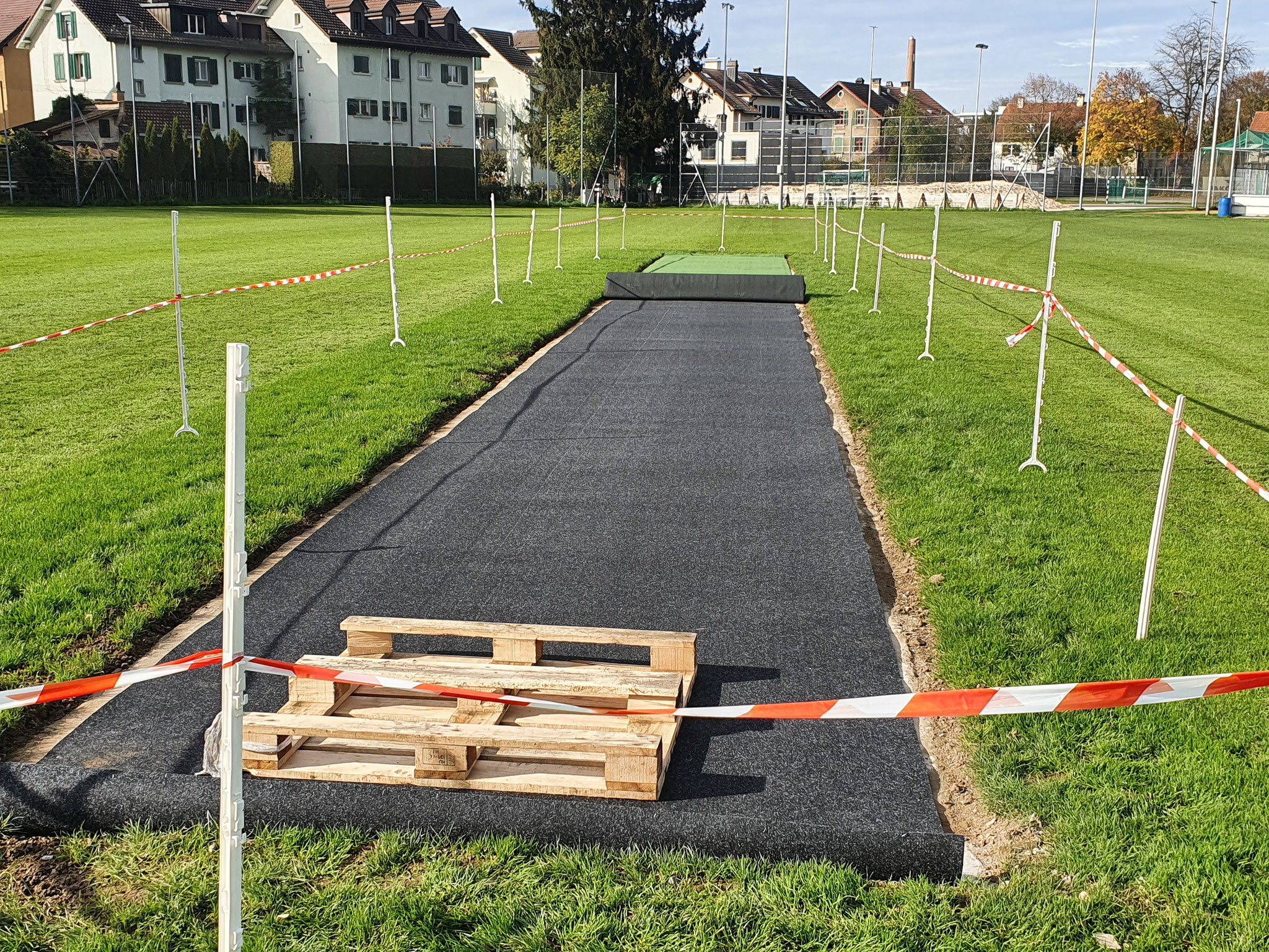 After resurfacing the concrete slab, the shockpad underlay was glued and nailed into place.