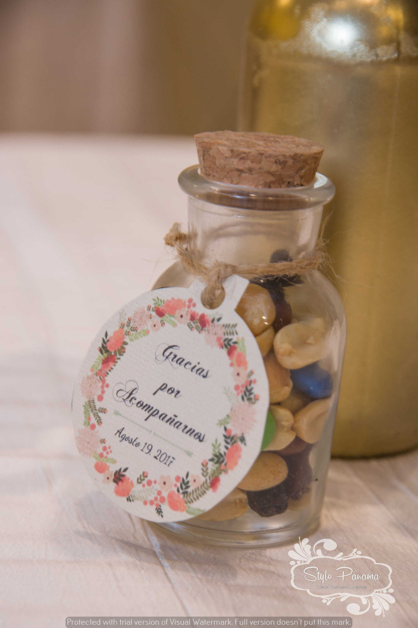 Mini masón jar con variedad de nueces, frutos secos y chocolates con etiqueta personalizada de la boda