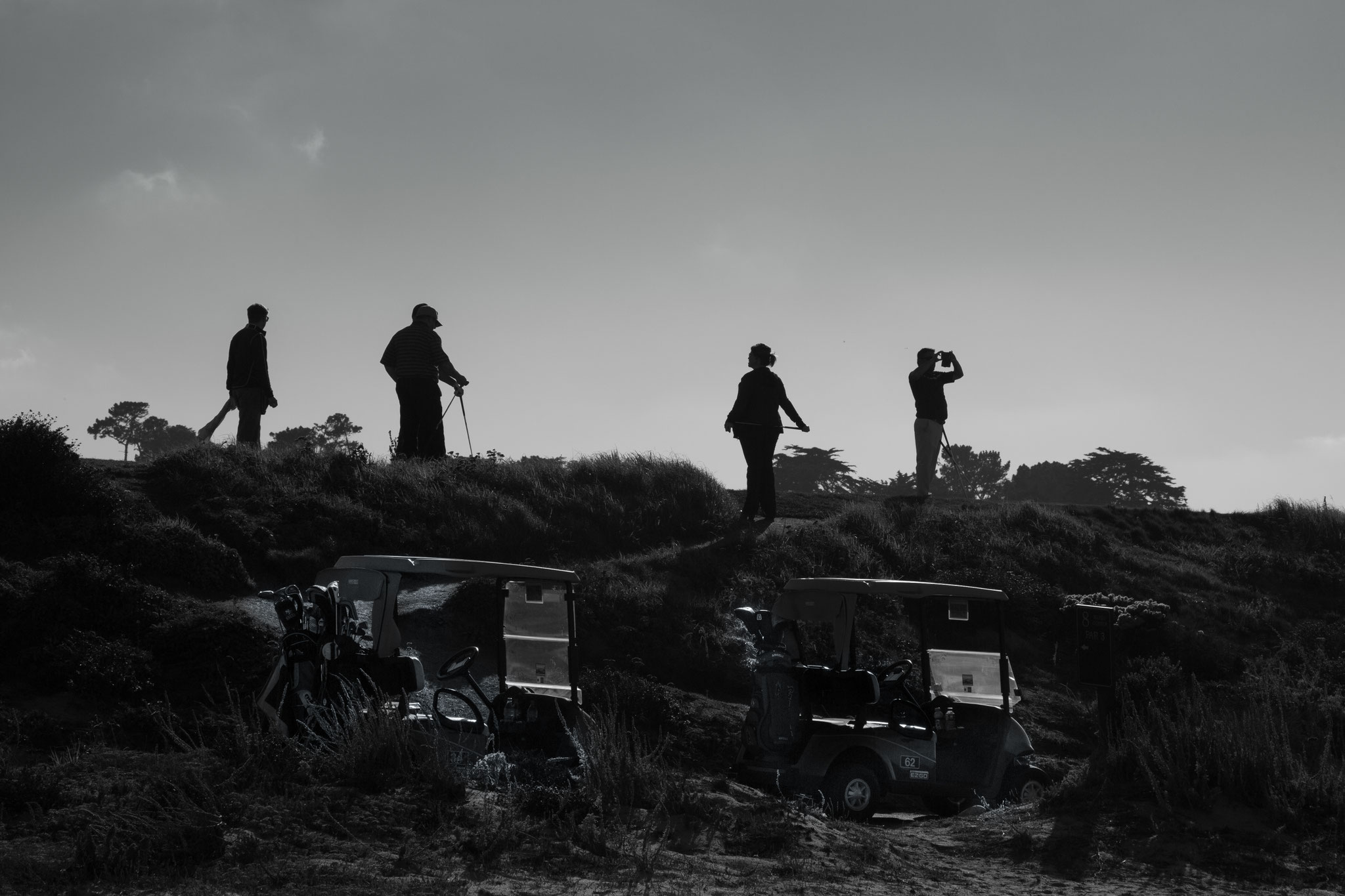 Golfers taking a picture from the Pacific Ocean in Pebble Beach, California, USA (2015)
