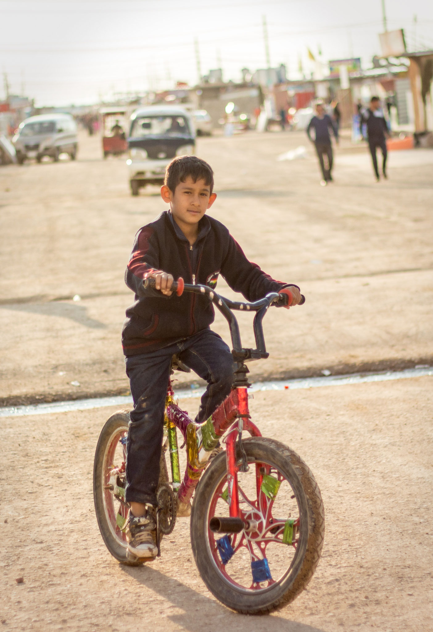 Syrian boy riding his bike in Domiz refugee camp in Kurdistan/Iraq. March 2017. 