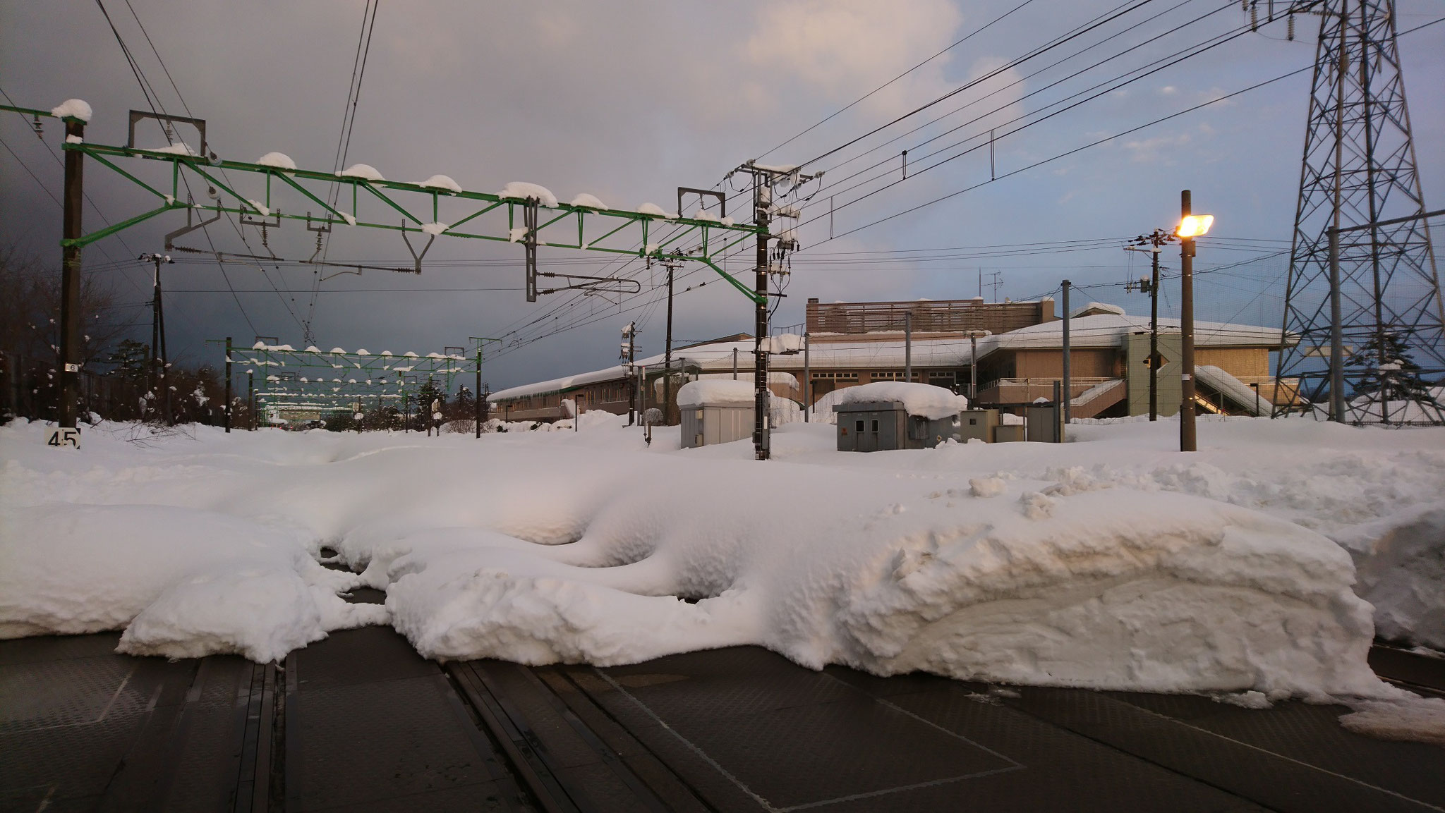 画像に見える建物が当施設。隣のJR信越本線は除雪されていません。