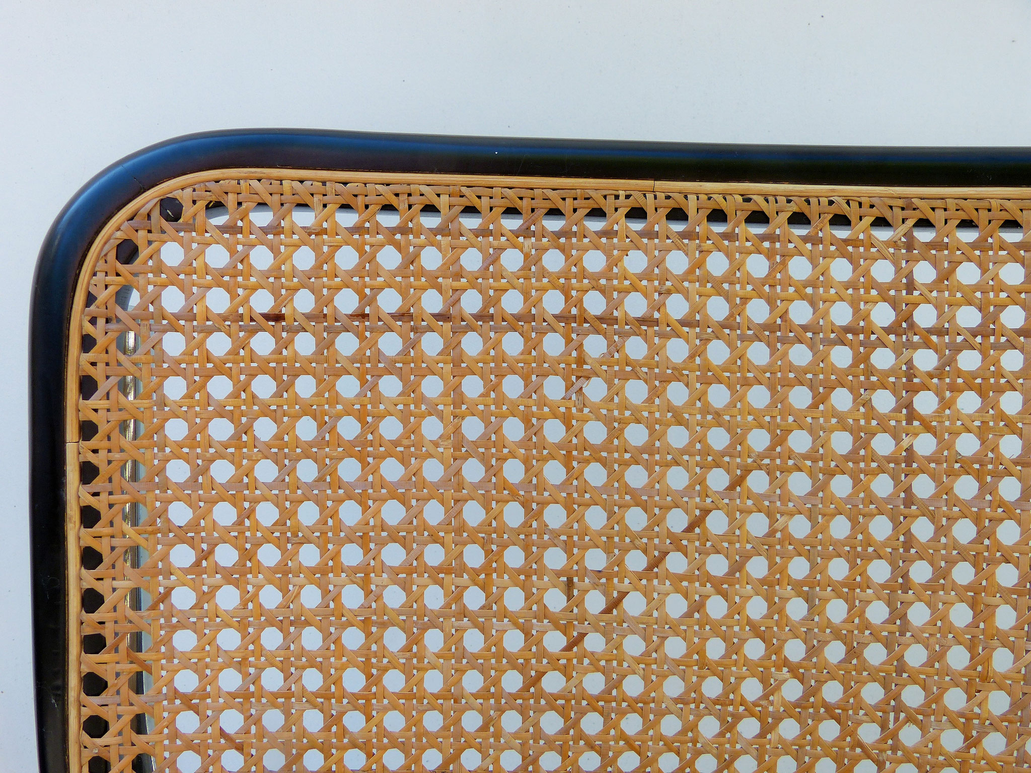 Smooth border in a groove, on a modern seat made for mechanical cane work.