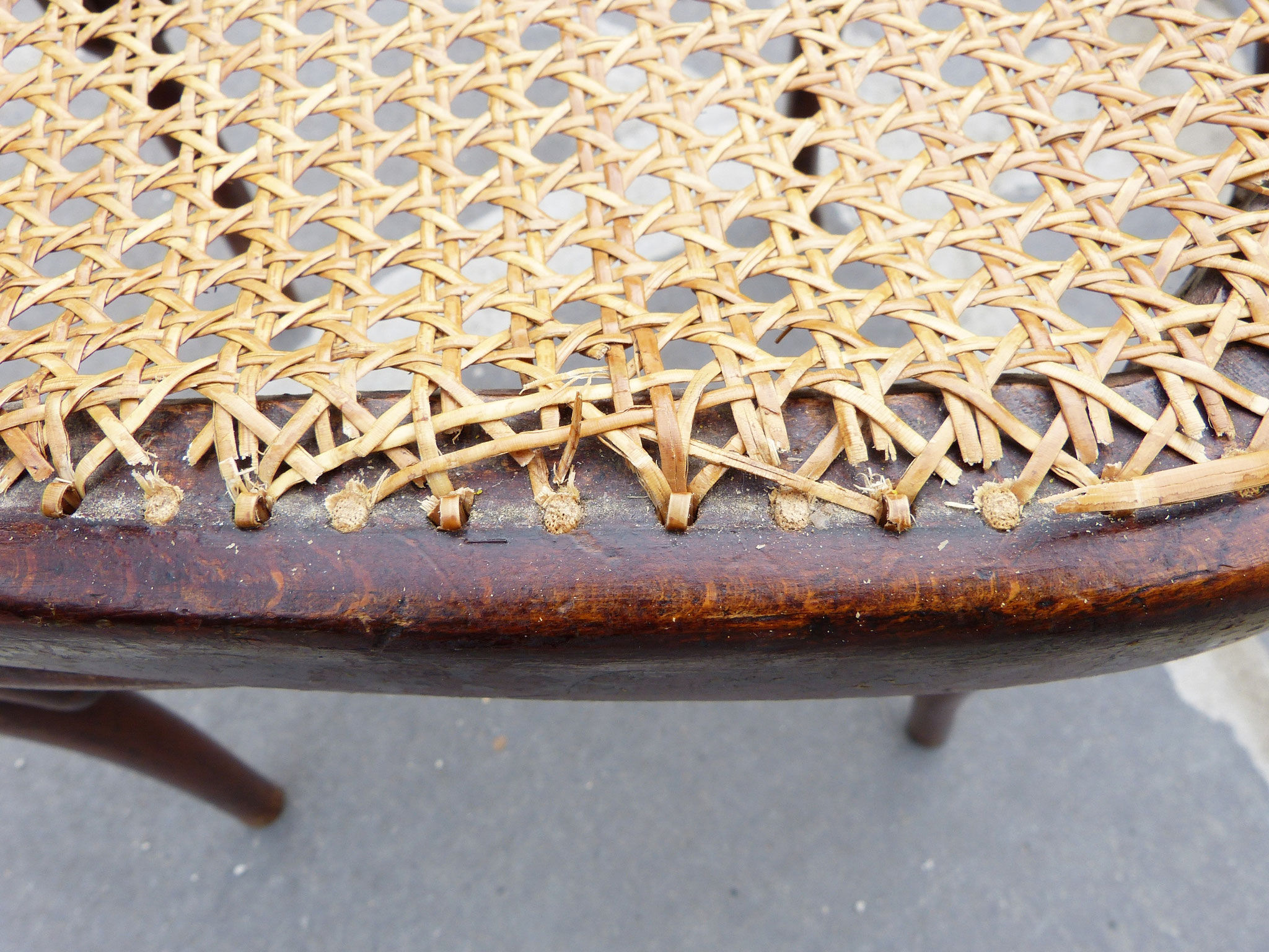 Modern pressed cane work glue on a antique seat.
