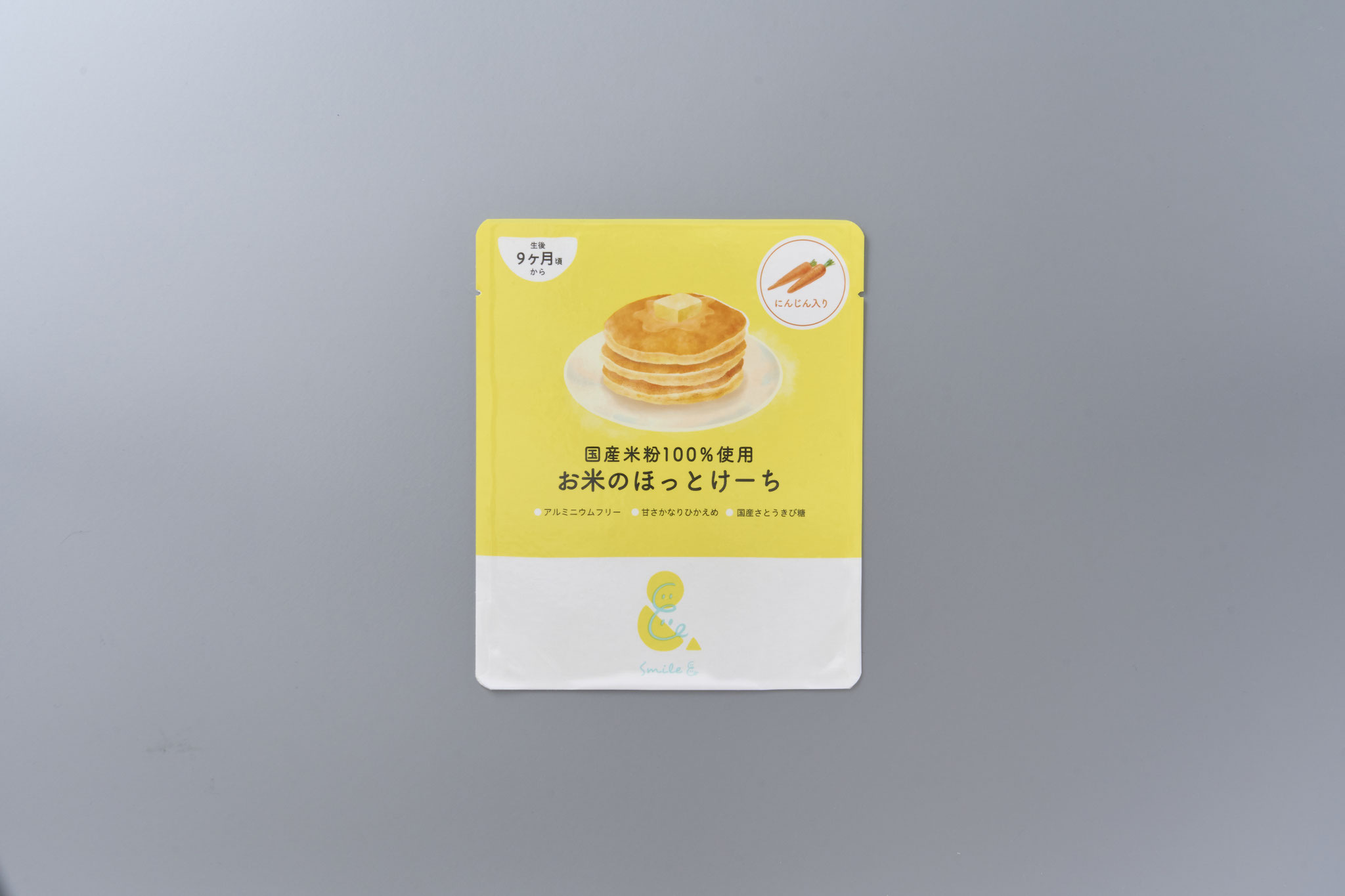 <div style=" font-size:10px; font-weight:bold;"> お米のほっとけーち にんじん入り </div> <div style=" font-size:10px;"> 国産米粉をベースに、にんじんの粉末をミックスしたホットケーキミックス粉(アルミニウムフリー) </div>