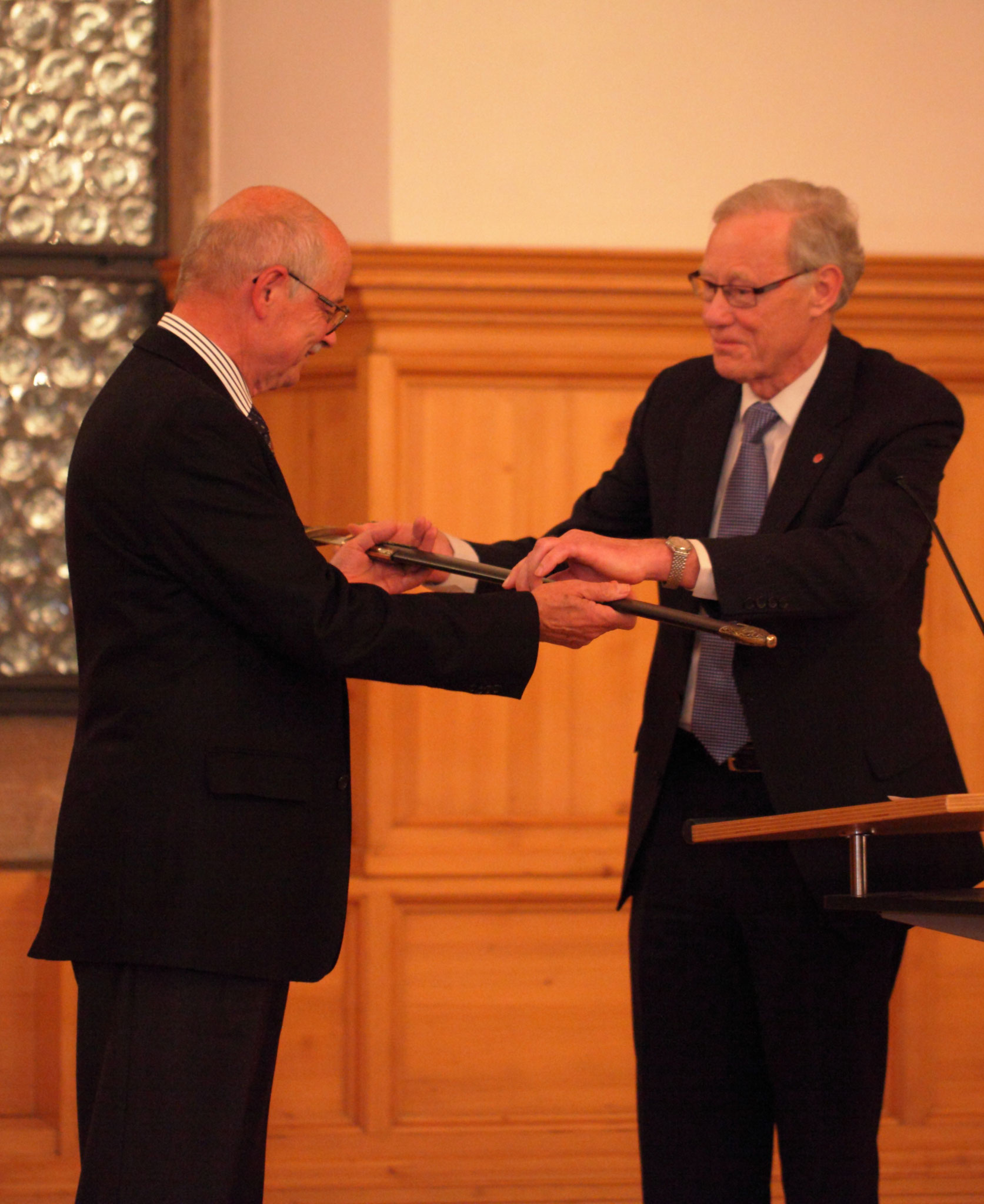 Prof. Johan Meijer (right) is giving the Knights' sword to Prof. Manfred Geiger (left) at LANE 2012