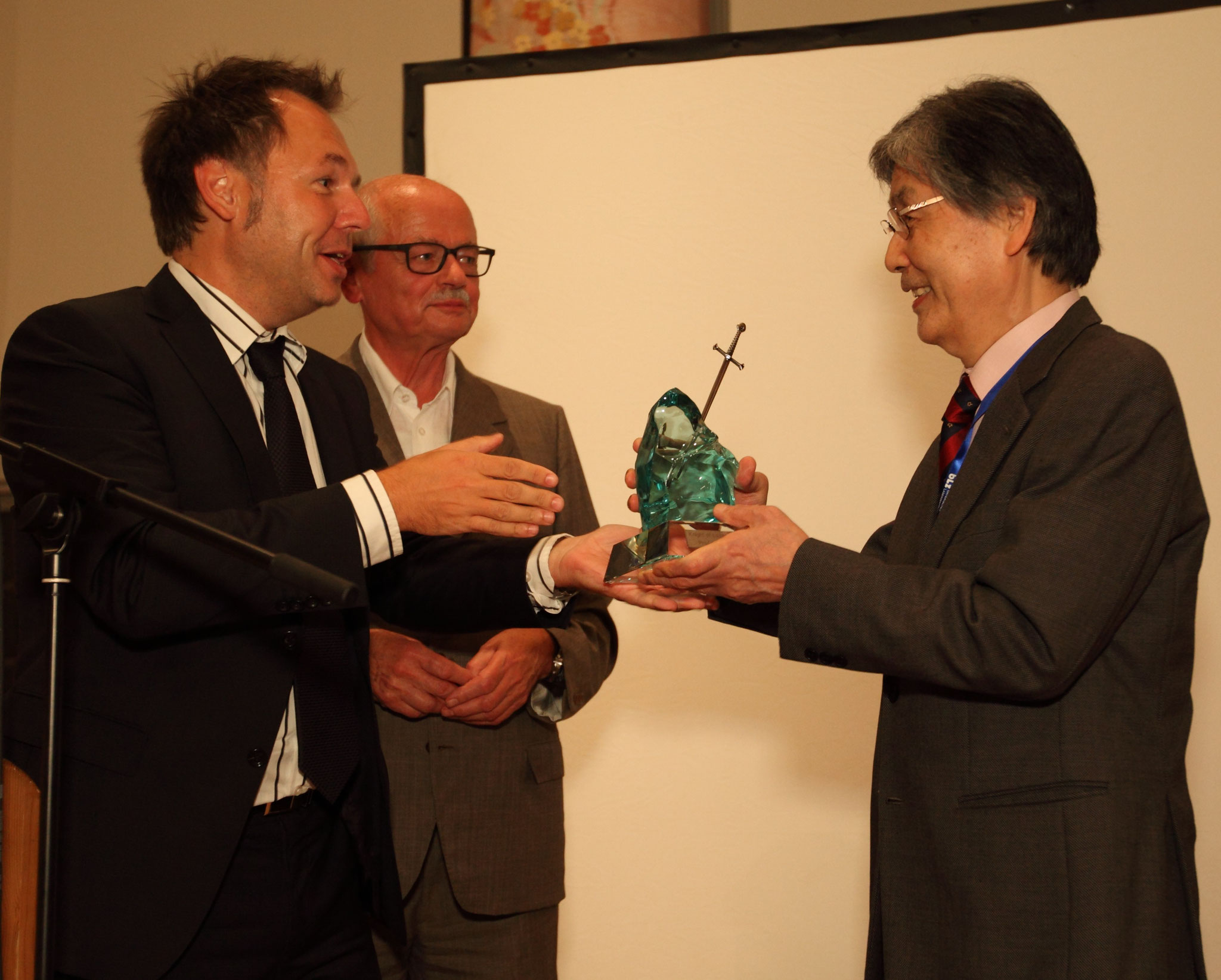 Conference chair Prof. Michael Schmidt, "old" Knight of Laser Technology Prof. Manfred Geiger and "new" Knight of Laser Technology Prof. Isamu Miyamoto during the Conference Banquet  in 2014 (from left to right)