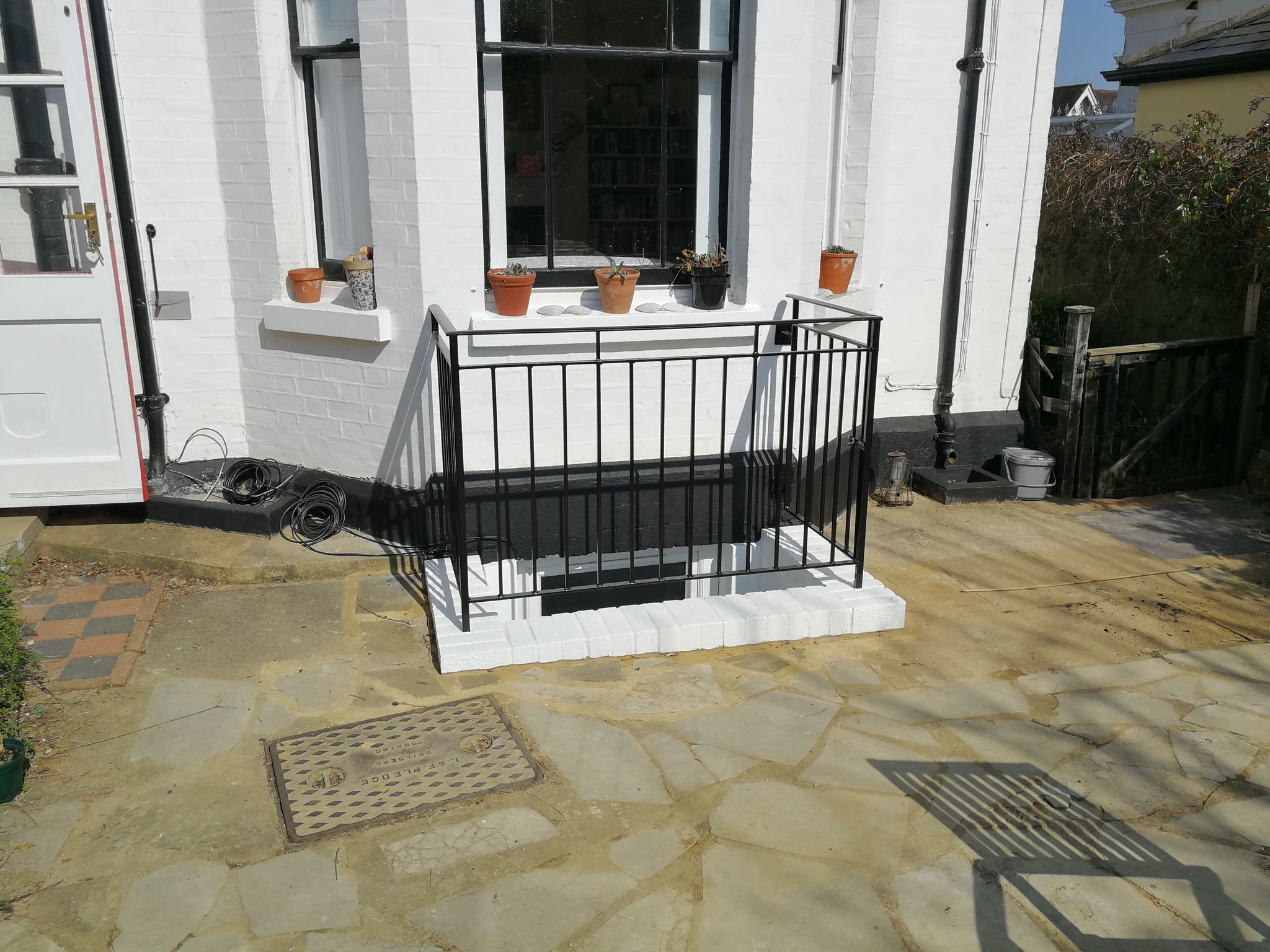 After - new railings and escape gate around the lightwell