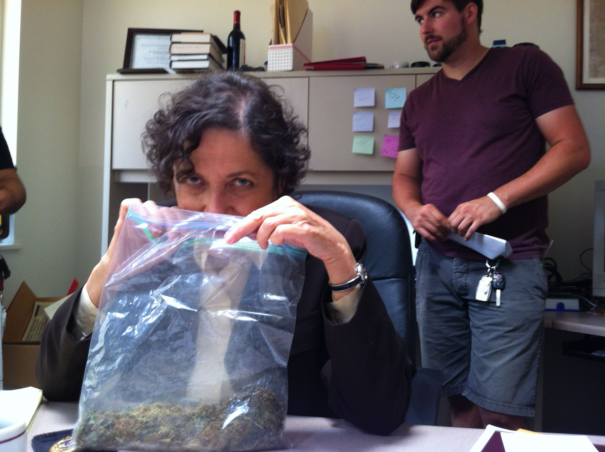 Director Les (Joette Waters) smellin' the goods in her office as the crew sets up a shot.