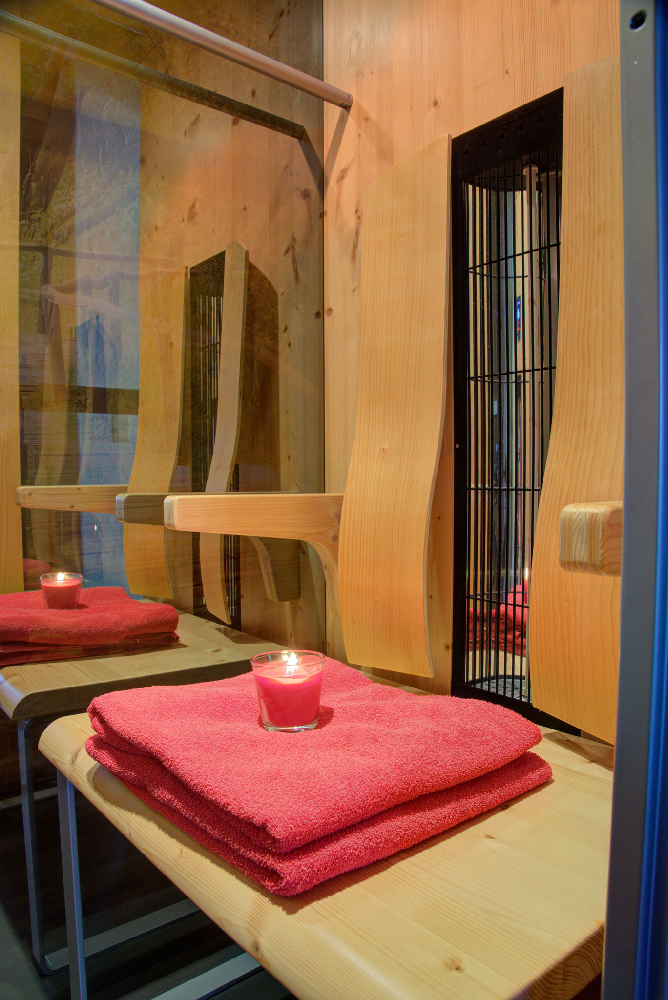 infrarotsauna mit rotem handtuch und teelicht in ferienhaus