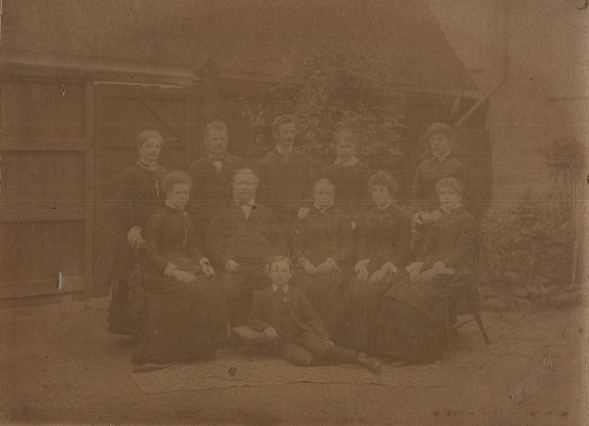 The Hodson Family, Elsworth, Brook Street. From left right, back row, Alberta, ?,?,?, Flora; middle row, ?, William, Jane, Clara Jane, ?; Martin in front.