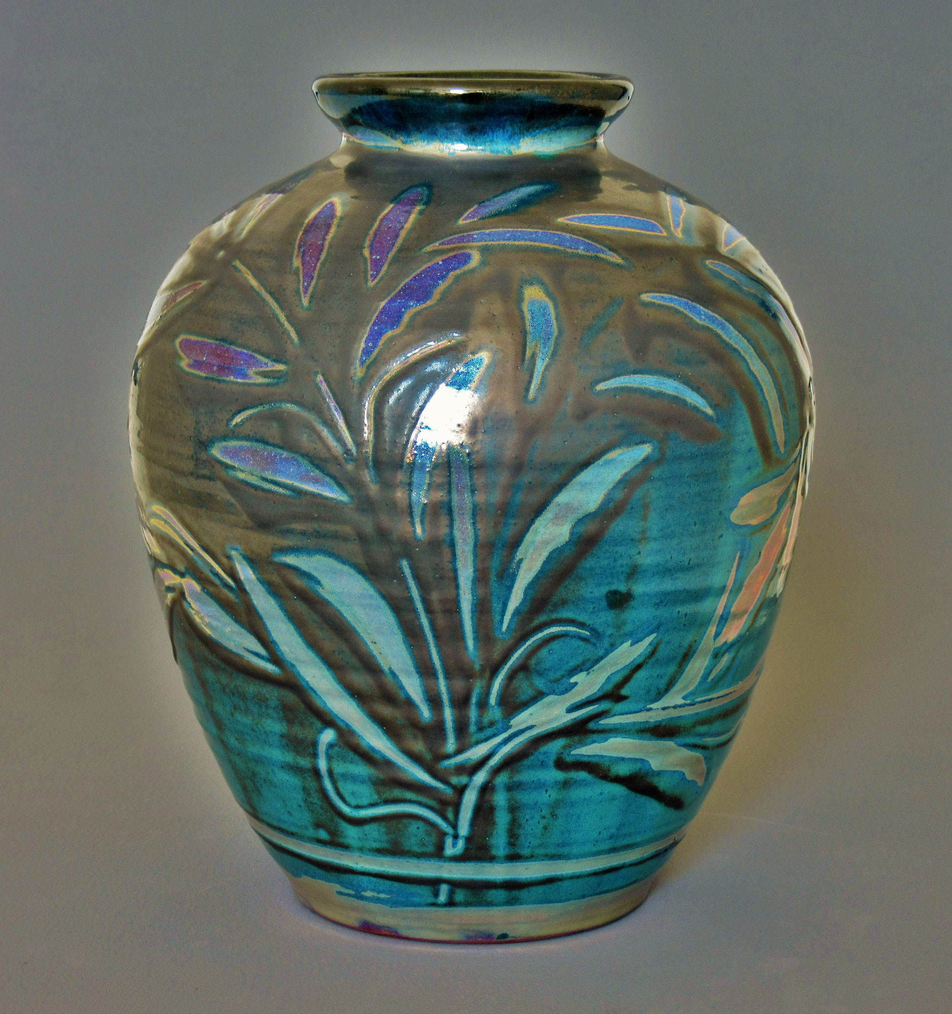 7ib thrown vase(ht: 30cm). Pewter-blue slip with foliate (lustre) design.SOLD