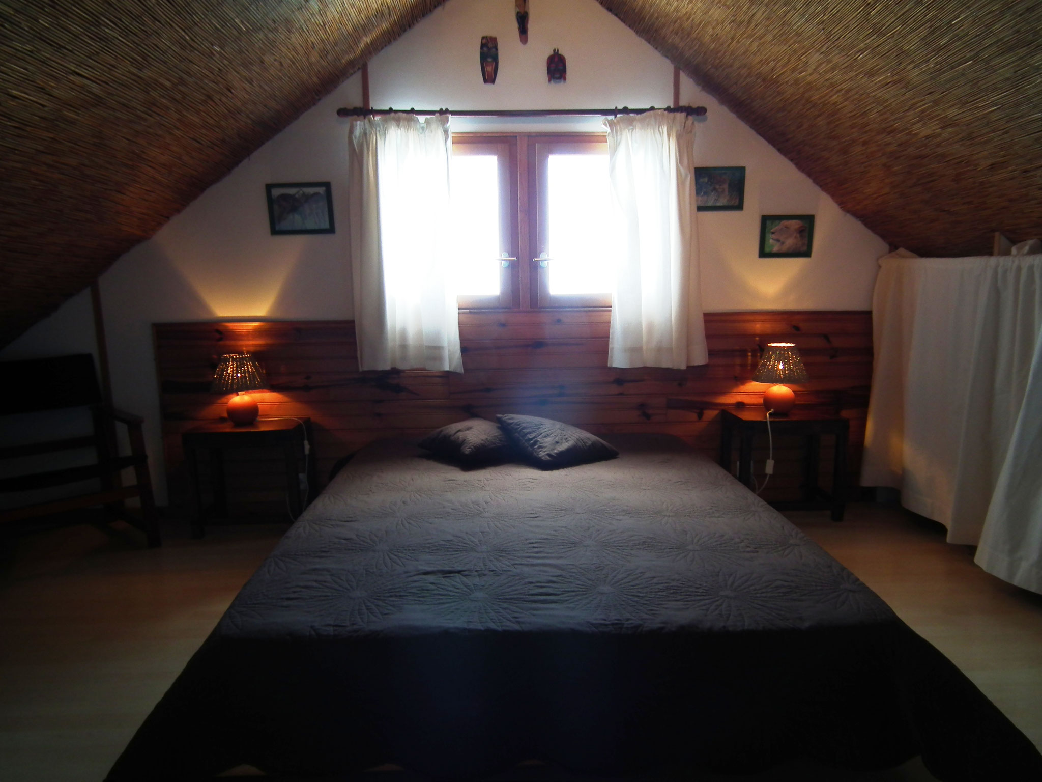 Atmospheric double bedroom with dark bedding and wooden shutters, Bungalow 9 T4, Le Cardinal des Grands Bleus