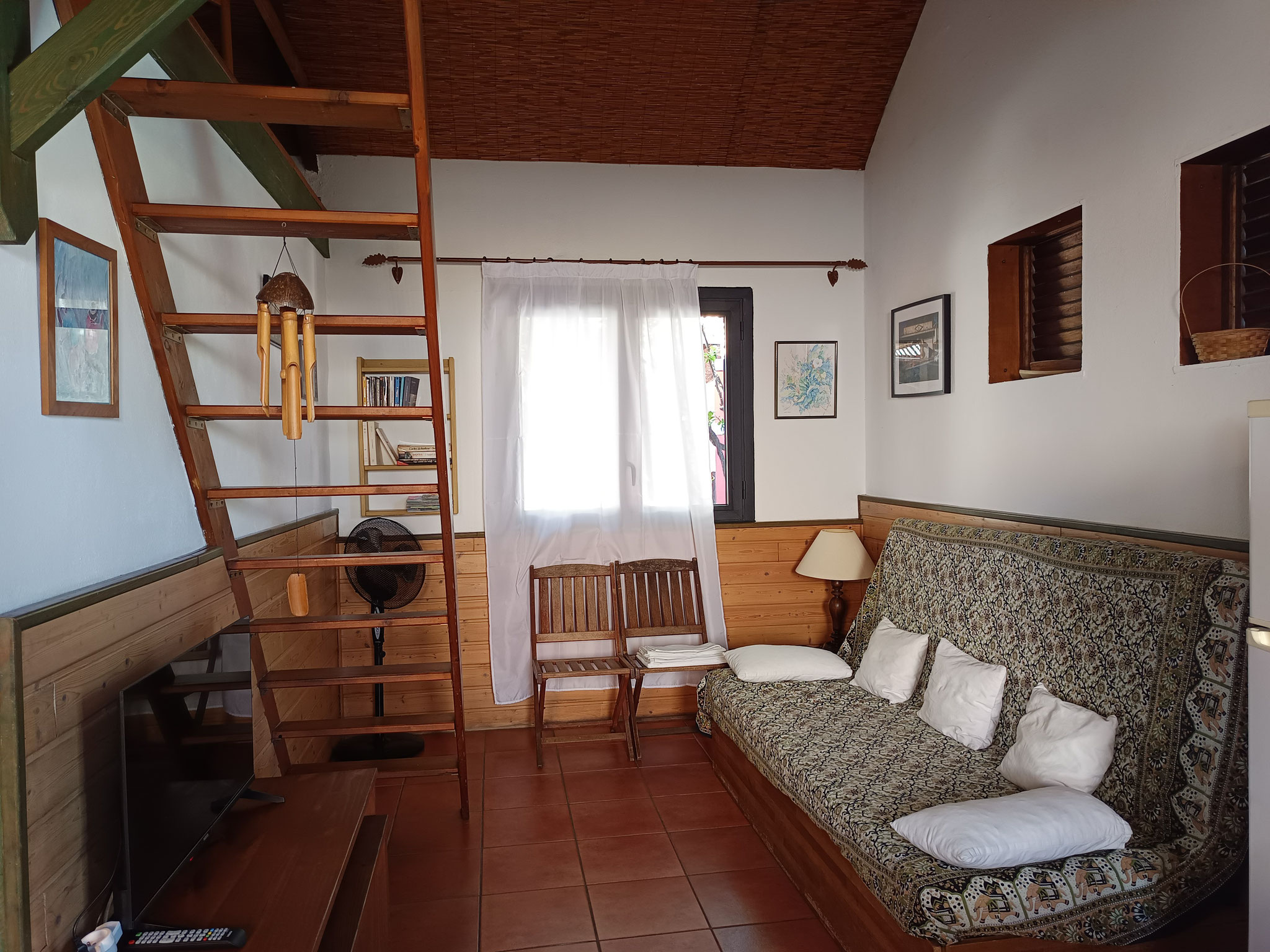 Spacious living room with sofa and mezzanine staircase, Bungalow 6 T3, Le Cardinal des Grands Bleus Saint-Leu