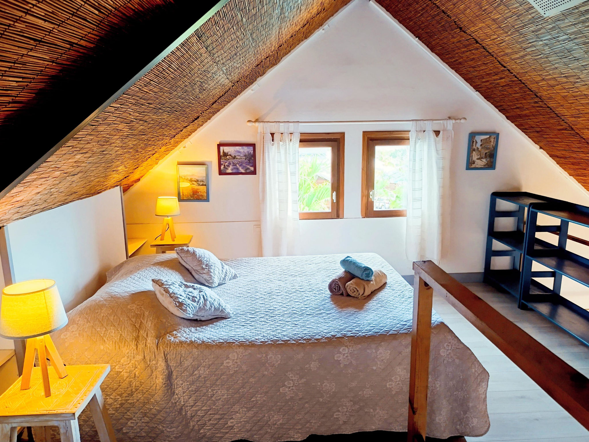 Double bedroom in mezzanine with cathedral ceiling and warm lighting, Bungalow 7 T3, Le Cardinal des Grands Bleus