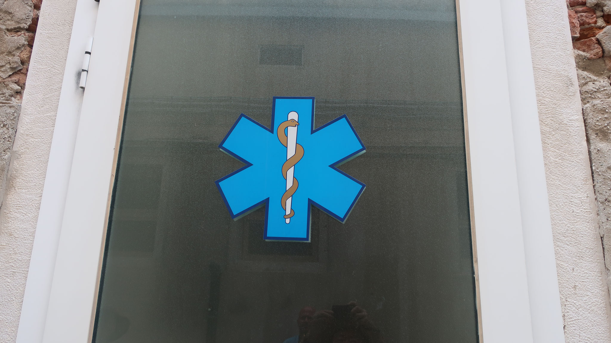 The rod of Asclepius at the door of the emergency department