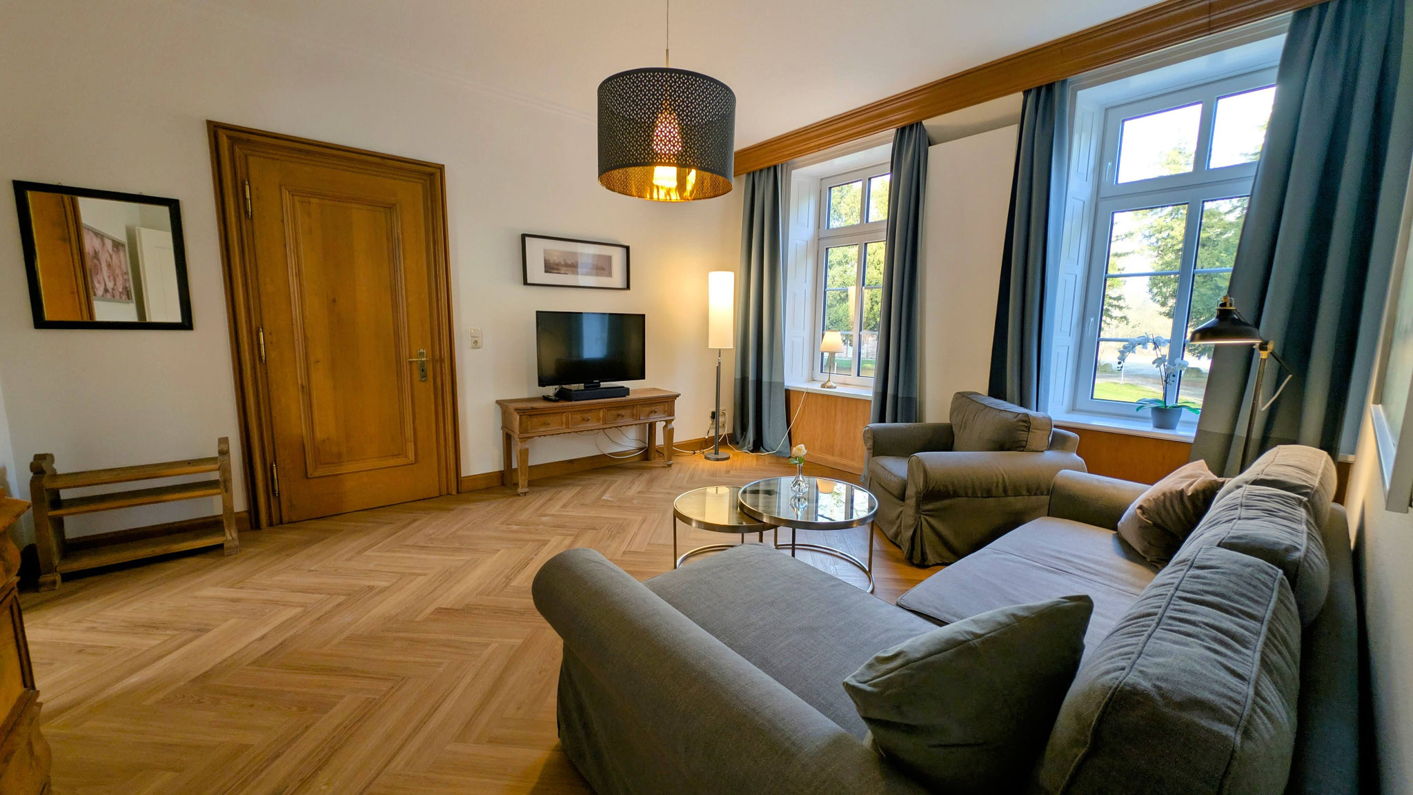 Stilvolles Wohnzimmer im Herrenhaus-Stil: Hochwertige Sitzgruppe und antikes Flair für entspannte Stunden bei Familie Thomsen-Detlefs auf Fehmarn.