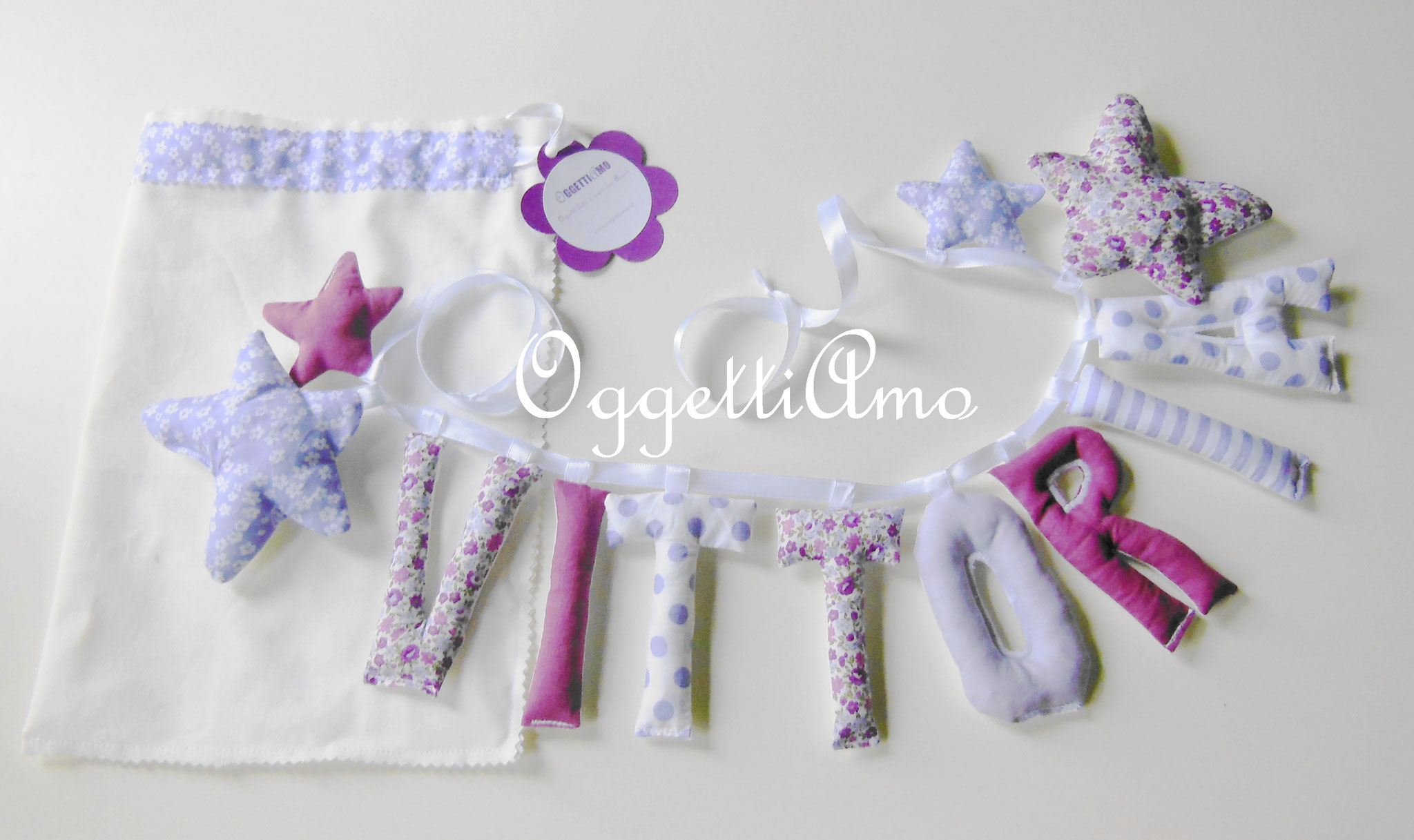 Ghirlande di lettere imbottite per decorare la cameretta di Vittoria con il suo nome in lilla e viola