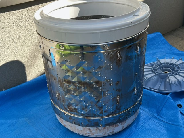 洗濯機ドラム洗浄前の状態。裏側にカビや石鹸汚れが付着し、分解洗浄が必要な状態。