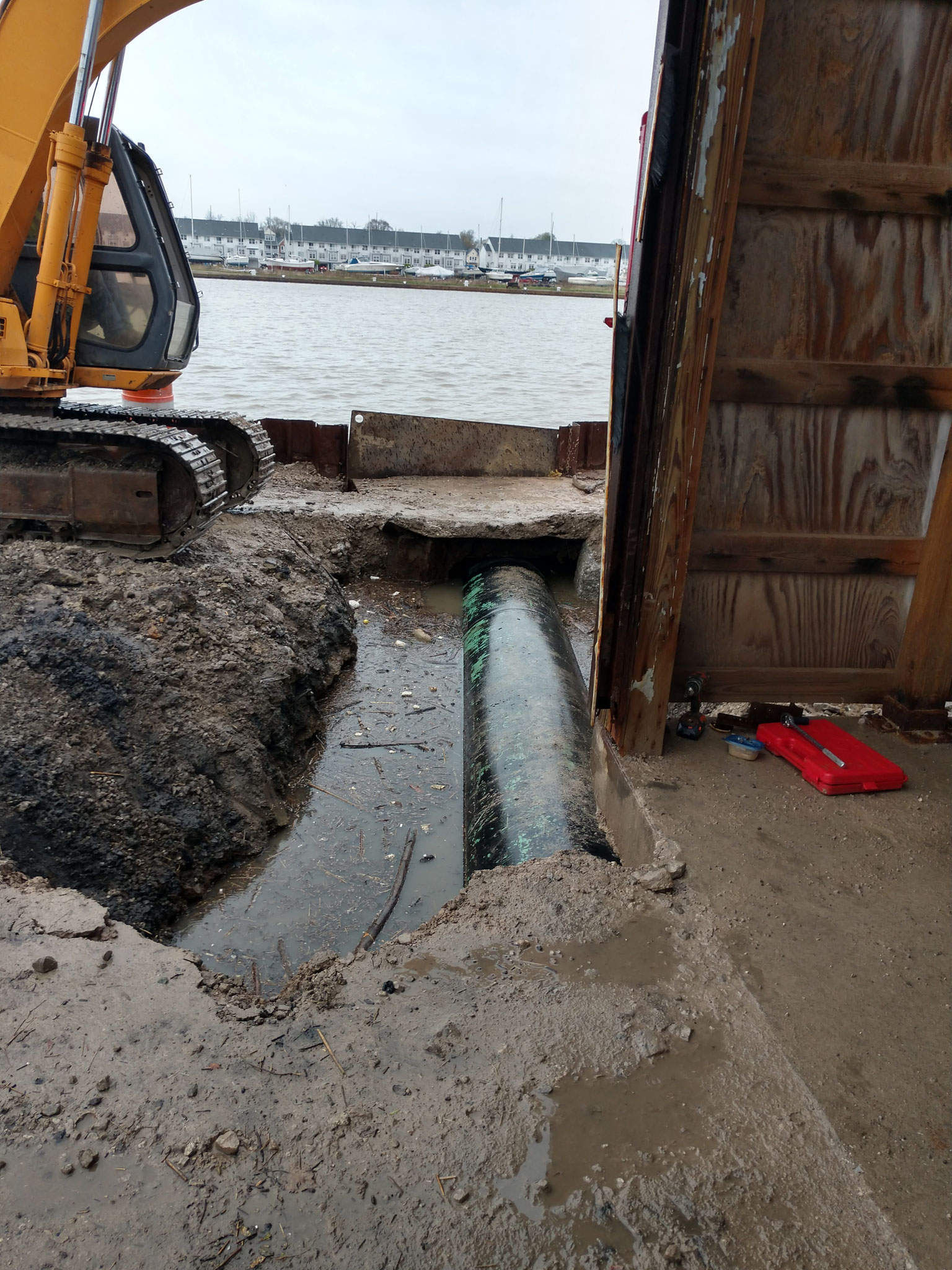 Riverfront municipal storm sewer repair with industrial building encroachment