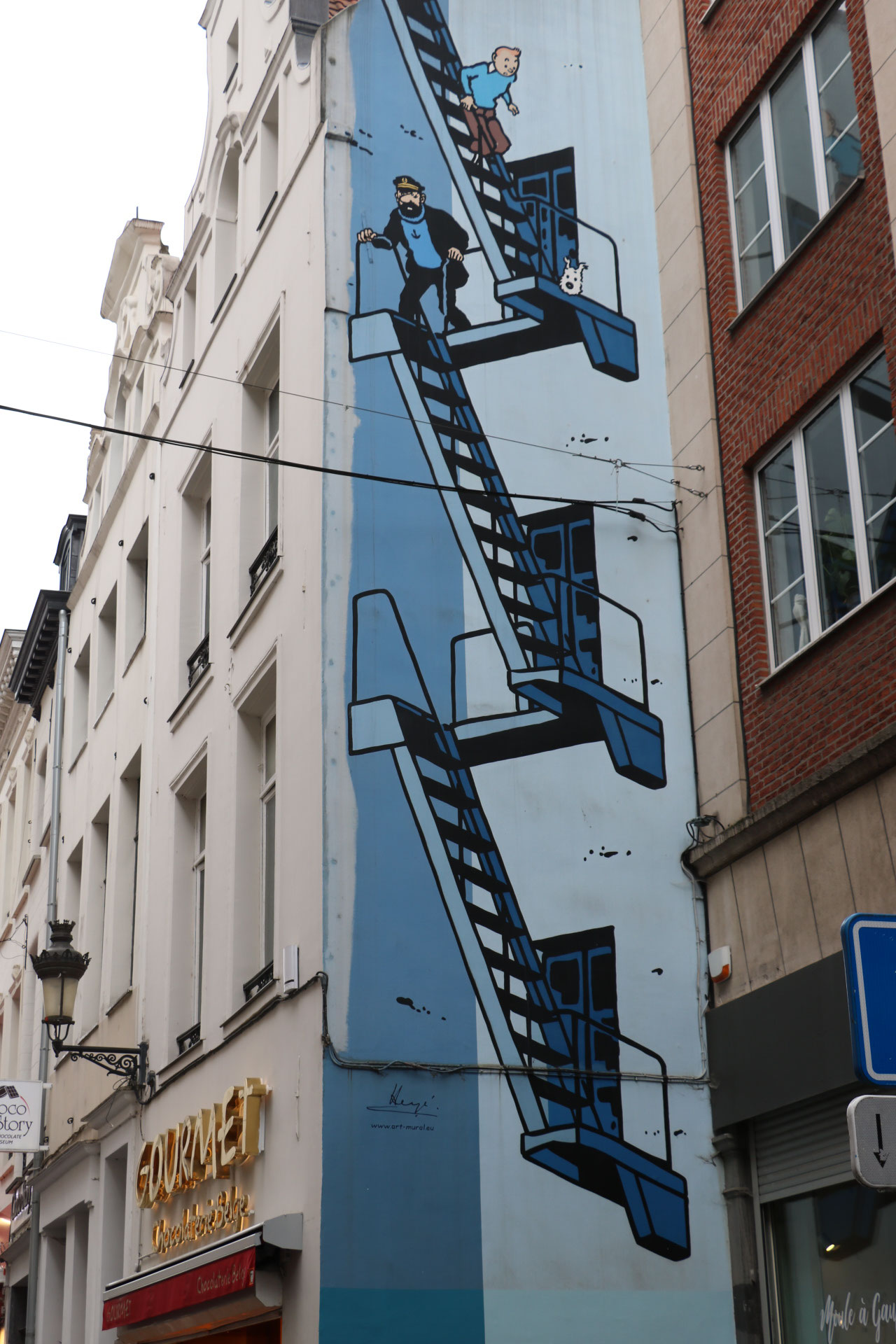 Rue de l'Étuve - Une des fresques dédiées à Hergé…<br/><a href="https://www.tintin.com/fr/news/5691/se-promener-avec-tintin-a-bruxelles" target="_blank"><em style="color: #666;">plus d'infos</em></a>