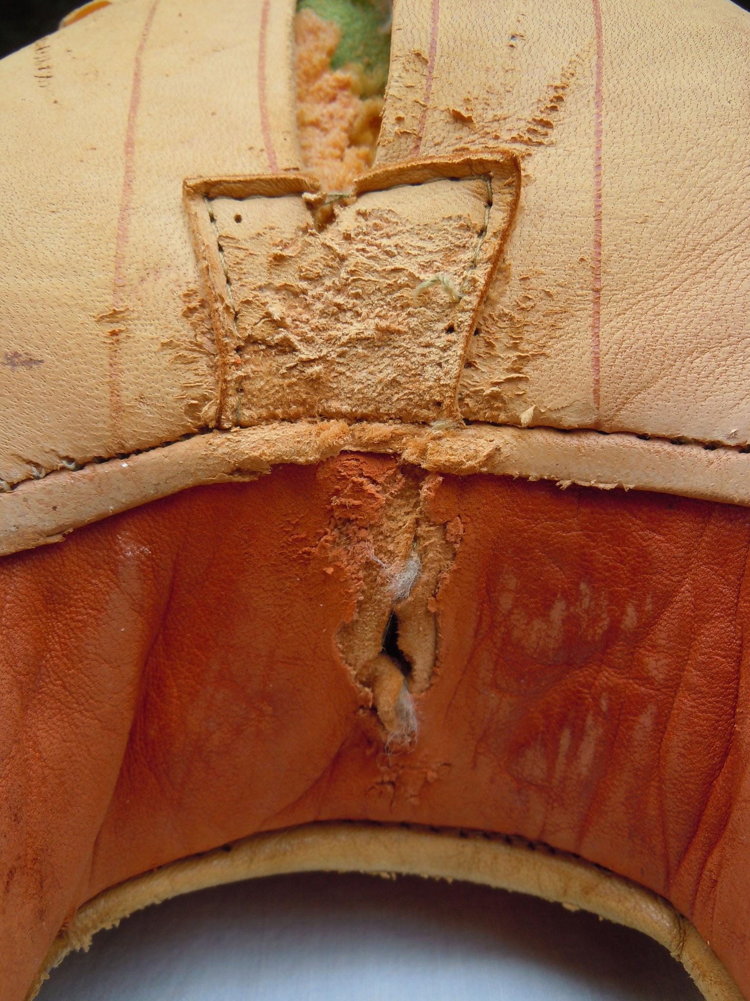The second enforcement patch on the opposite side "only" torn, but below the same damage to the red leather.