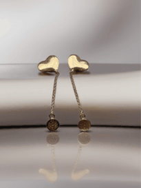 MOKOŠEV luxury jewelry, delicate gold heart earrings with fine chains on a soft, reflective surface.