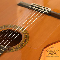 Soundboard adorned with a rosette and strings of a concert guitar handmade by Miguel Mateo.