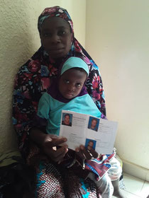 Ouagadougou. A TOND LAAFI beneficiary presenting her mutual insurance card with her covered family members.