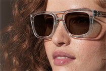 Frau mit Sonnenbrille und Transitionsgläsern