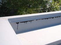 Failure of metal parapet under-flashing