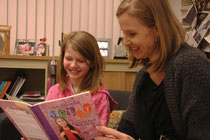 Desiree Sweetapple, 10, left, and her mom Tracey take a look at a book about living with ADHD. Desiree became more interested in learning about her condition after attending the GLOW for LD/ADHD program. TESSA CLAYTON/AIRDRIE ECHO