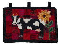 rug hooked black and white cow with sun flower on red and black background