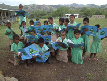 Children looking at worksheet and learnning how to plan trees.