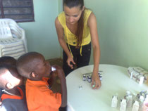 Project Coordinator, Stella Bili giving medicine to the children
