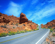 Clear highway cutting through mountainous region