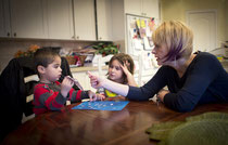 Simone Papernick and her daughter Isabelle encourage her son Noah, 3, to identify characters on stickers in their Brooklin home. When he was diagnosed a year ago, Papernick says she was advised it could take six years to get intensive therapy. 