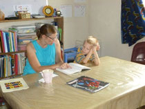 Mommy teaching Elijah on the first day of school.