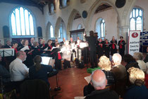 Choir in full voice with Musical Director Michael Fletcher