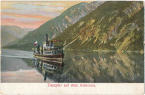 Schraubenraddampfer (Stapellauf 1887, seit 1950 Motorschiff) "St. Joseph" der Achenseeschifffahrt auf  Rundfahrt durch spiegelglattes Seewasser. Photochromdruck 9 x 14 cm; Impressum: A. B. D. Serie No. 460 um 1900.  Inv.-Nr. vu914kfd00047