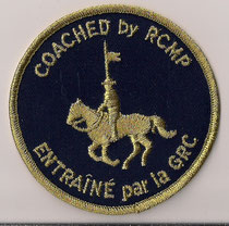 Coached by RCMP - Entraîné par la GRC  (Fond bleu foncé / Navy blue background)  (Contour or / Gold border)  (Bilingue / Bilingual)