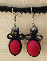 Boucle d'oreille pendentif ornée de chambre à air composée d'une perle en bois rouge et et d'une perle en métal.