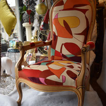 Couverture d'un fauteuil style Voltaire avec un tissu de la Maison ZEPHYR & co. Finition avec double passepoil des Passementeries de l’île de France.
